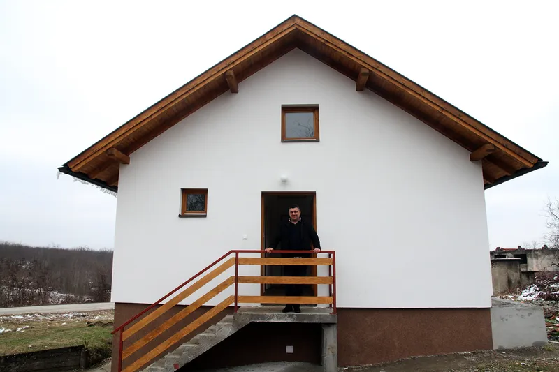 RHP Beneficiary in front of his new home