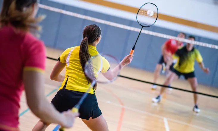 Young people playing badminton